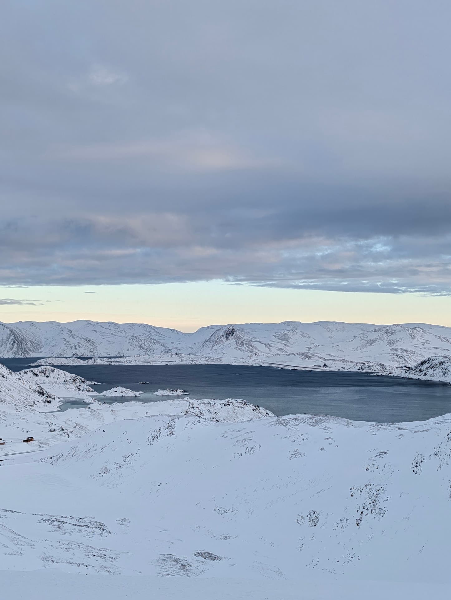 Blick vom Nordkapp-Plateau aufs arktische Meer bei klarer Sicht und tiefstehender Wintersonne.